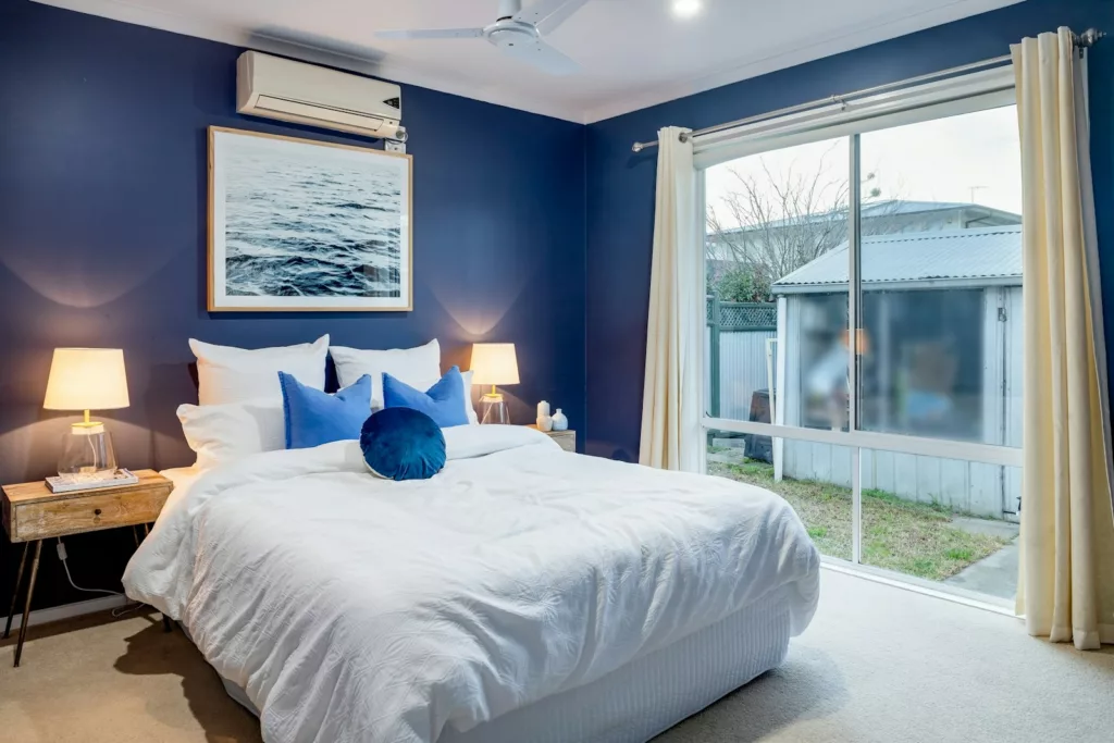 A Guide to Furnishing Your Luxurious Apartment in Accra, Ghana a bedroom with blue walls and a white bed
